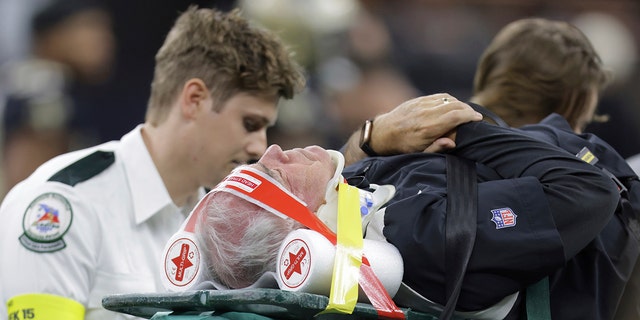 Atlanta Falcons defensive coordinator Dean Pees on a backboard.