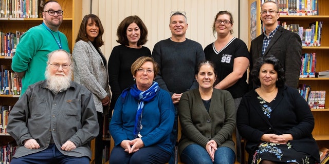 A 2018 photo of the Dedham Human Rights Commission, in which Loud is pictured in the front row, third from left.