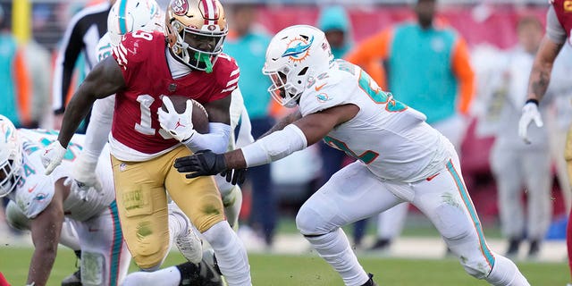 San Francisco 49ers wide receiver Deebo Samuel, #19, runs against Miami Dolphins linebacker Elandon Roberts during the second half of an NFL football game in Santa Clara, California, Sunday, Dec. 4, 2022. 