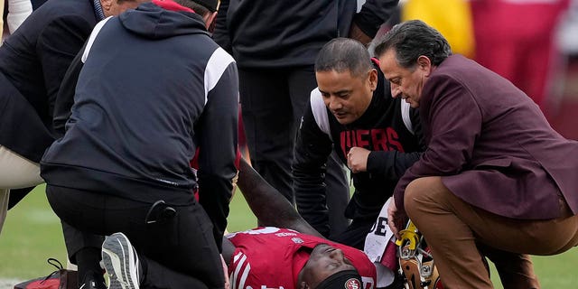 San Francisco 49ers wide receiver Deebo Samuel is checked before being carted off the field during the first half against the Tampa Bay Buccaneers in Santa Clara, California, Sunday, Dec. 11, 2022.