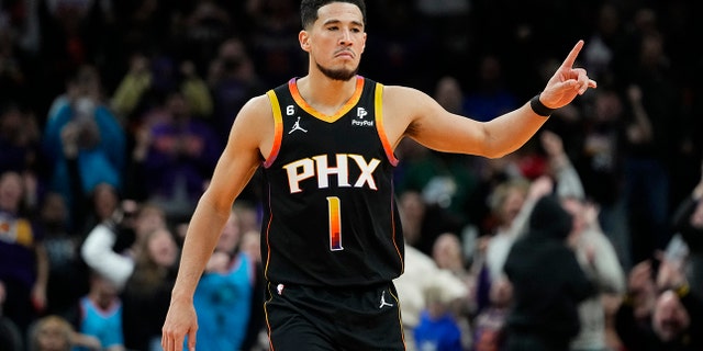 Suns guard Devin Booker reacts to a basket against the New Orleans Pelicans, Saturday, Dec. 17, 2022, in Phoenix.