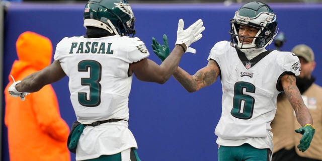 Philadelphia Eagles wide receiver DeVonta Smith (6) is congratulated by wide receiver Zach Pascal after scoring a touchdown against the New York Giants during the second quarter, Sunday, Dec. 11, 2022, in East Rutherford, New Jersey.