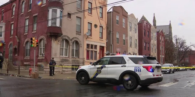 Police outside a home near Philadelphia's Temple University, where a triple shooting happened.