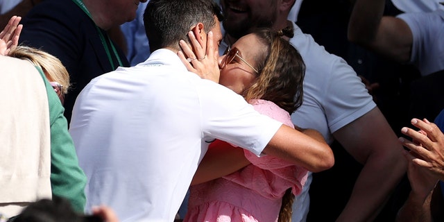Novak Djokovic celebrates with his wife Jelena after winning the men's singles final match against Nick Kyrgios at Wimbledon Tennis Championship in London on July 10, 2022.
