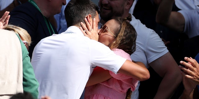 Novak Djokovic celebrates with his wife Jelena after winning the men's singles final match against Nick Kyrgios at Wimbledon Tennis Championship in London on July 10, 2022.