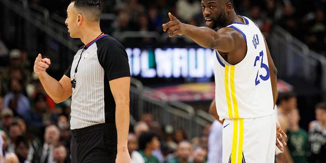 Golden State Warriors forward Draymond Green points out a fan in the stands during the Bucks game at Fiserv Forum on Dec. 13, 2022, in Milwaukee.