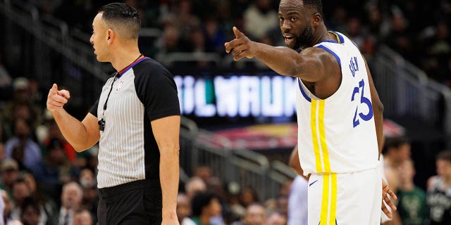 Golden State Warriors forward Draymond Green points to a fan in the stands during the Bucks game at the Fiserv Forum on December 13, 2022 in Milwaukee.