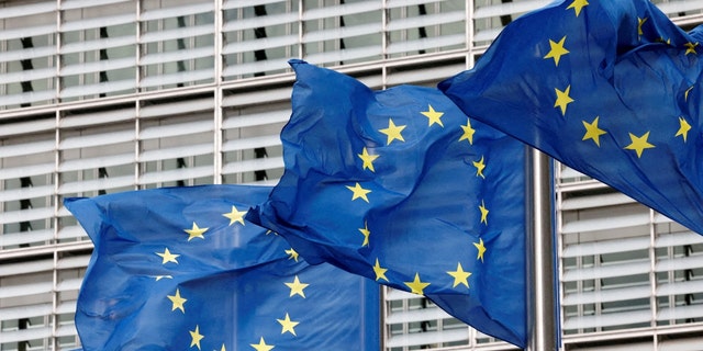 European Union flags flutter outside the EU Commission headquarters in Brussels Sept. 28, 2022. 