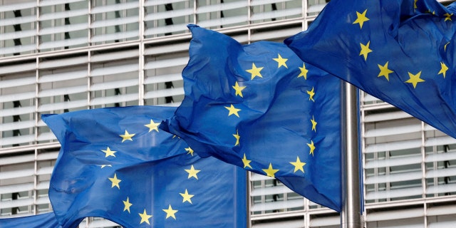 European Union flags flutter outside EU Commission headquarters in Brussels, Belgium, Sept. 28, 2022.