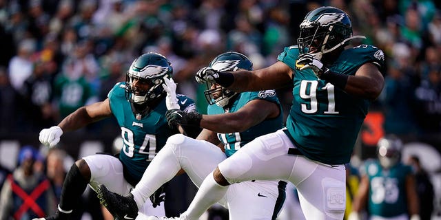 Philadelphia Eagles' Josh Sweat, from left, Javon Hargrave and Fletcher Cox celebrate a tackle by Hargrave during the first half of an NFL football game against the Tennessee Titans, Sunday, Dec. 4, 2022, in Philadelphia. 