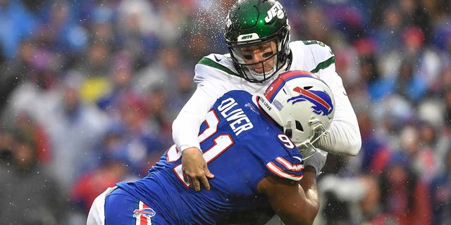 Buffalo Bills defensive tackle Ed Oliver (91) collides with New York Jets quarterback Mike White (5) during the first half of an NFL football game, Sunday, Dec. 11, 2022, in Orchard Park, N.Y. 