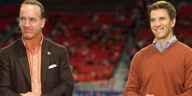 Former Football Quarterbacks Peyton Manning and Eli Manning talk prior to the SEC Championship game between the LSU Tigers and the Georgia Bulldogs at Mercedes-Benz Stadium on Dec. 3, 2022 in Atlanta.