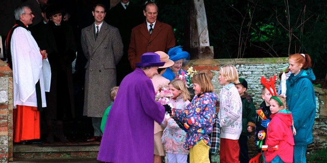 Queen Elizabeth II receiving flowers from children after the Christmas Service at Sandringham Church on Dec. 25, 1994. Ashenden said the queen used her Christmas messages to promote Christian faith.