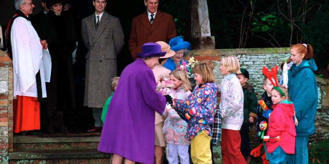 Queen Elizabeth II receiving flowers from children after the Christmas Service at Sandringham Church on Dec. 25, 1994. Ashenden said the queen used her Christmas messages to promote Christian faith.