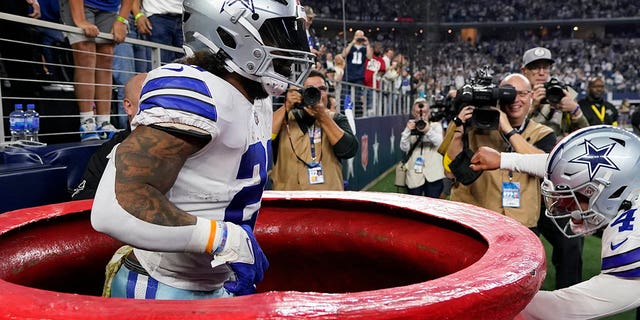 Dallas Cowboys' Ezekiel Elliott, #21, celebrates a touchdown run during the second half of an NFL football game against the Indianapolis Colts, Sunday, Dec. 4, 2022, in Arlington, Texas. 
