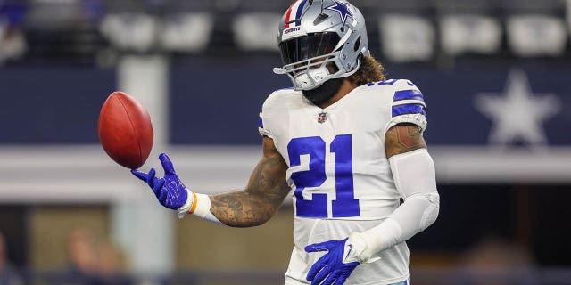 Dallas Cowboys running back Ezekiel Elliott, #21, spins the ball during the game between the Dallas Cowboys and the Indianapolis Colts on Dec. 4, 2022 at AT&T Stadium in Arlington, Texas.