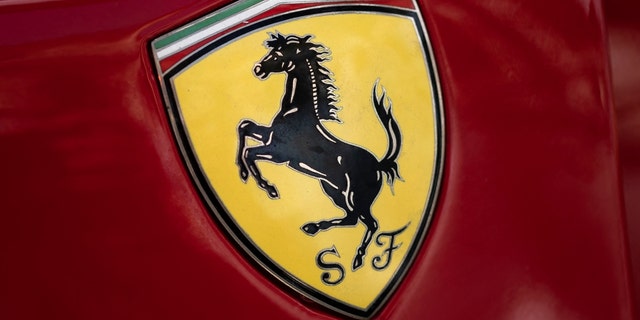 The logo of Italian manufacturer of luxury sports cars Ferrari is pictured on a car in Modena, Northern Italy.