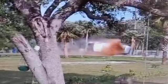 Cooking oil is seen flying into the air as a truck crashed Thursday in Fort Myers, Florida.