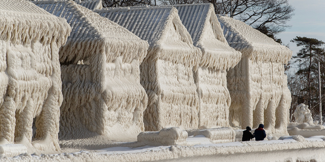 Homes are seen covered in ice in Fort Erie, Ontario, on Wednesday, Dec. 28.