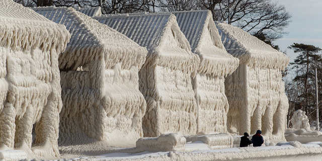 Homes are seen covered in ice in Fort Erie, Ontario, on Wednesday, Dec. 28.