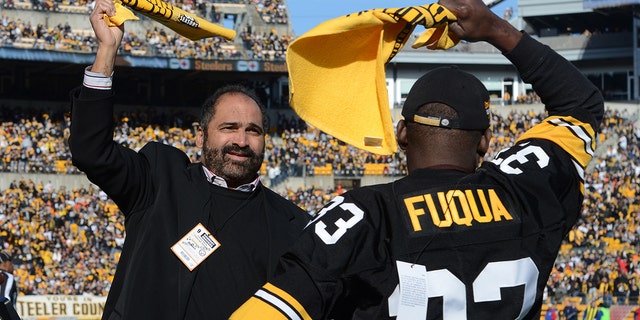 Franco Harris, left, and John Fuqua, former running backs for the Pittsburgh Steelers, wave Terrible Towels before a game between the Steelers and Cincinnati Bengals at Heinz Field Dec. 23, 2012, in Pittsburgh.