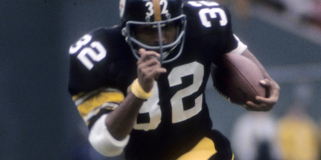 Pittsburgh Steelers running back Franco Harris carries the ball against the Denver Broncos circa mid-1970s at Three Rivers Stadium in Pittsburgh. Harris played for the Steelers from 1972-83.