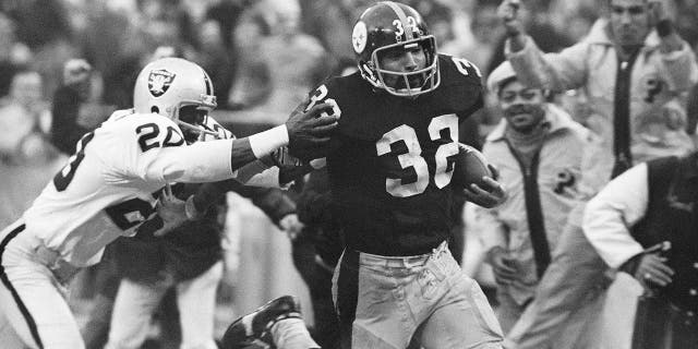 FILE - Pittsburgh Steelers' Franco Harris (32) eludes a tackle by Oakland Raiders' Jimmy Warren as he runs 42-yards for a touchdown after catching a deflected pass during an AFC Divisional NFL football playoff game in Pittsburgh, Dec. 23, 1972.