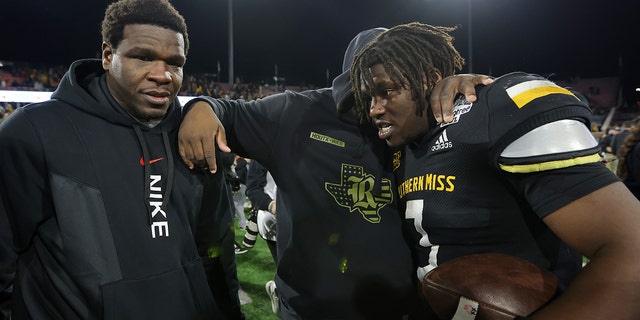 Frank Gore Jr. of the Southern Miss Golden Eagles celebrates with his father, former NFL running back Frank Gore, after winning the LendingTree Bowl at Hancock Whitney Stadium on Dec. 17, 2022, in Mobile, Alabama.