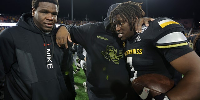 Frank Gore Jr. of the Southern Miss Golden Eagles celebrates with his father, former NFL running back Frank Gore, after winning the LendingTree Bowl at Hancock Whitney Stadium on Dec. 17, 2022, in Mobile, Alabama.