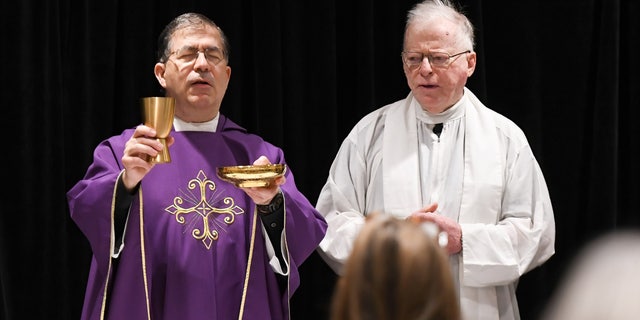 Father Frank Pavone, left, celebrates Catholic Mass for attendees at the 2021 Conservative Political Action Conference at the Hyatt Regency in Orlando, Florida, on Feb. 27, 2021.
