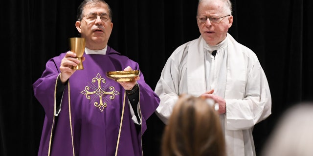 Father Frank Pavone, left, celebrates Catholic Mass for attendees at the 2021 Conservative Political Action Conference at the Hyatt Regency in Orlando, Florida, on Feb. 27, 2021.