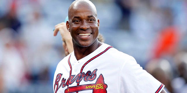 Former Atlanta Braves first baseman Fred McGriff smiles on the field before a game against the Miami Marlins, Aug. 7, 2015, in Atlanta.