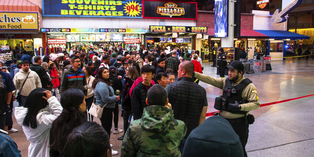 Las Vegas city marshals and security officers direct pedestrians at the downtown Fremont Street Experience casino mall on Wednesday, Dec. 28, after authorities say a man from Minnesota and a woman from New Mexico were struck and killed by an SUV at a busy pedestrian street crossing.
