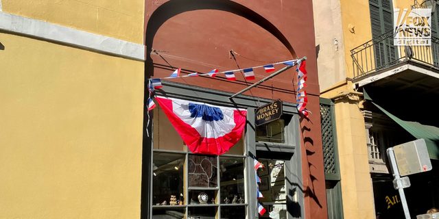 The Brass Monkey antique shop is one of the many businesses in the French Quarter that have decorated their storefronts ahead of President Emmanuel Macron's visit.