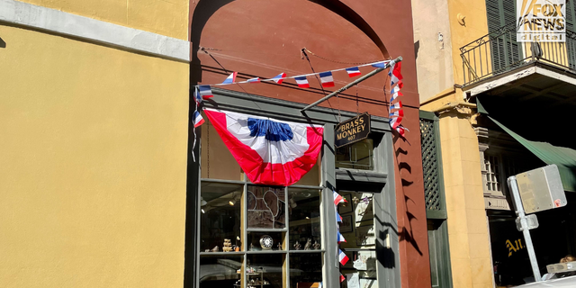 The Brass Monkey antique shop is one of the many businesses in the French Quarter that have decorated their storefronts ahead of President Emmanuel Macron's visit.