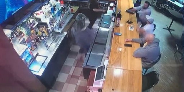 Attorney Gavin Rush points a gun at his ex-girlfriend, who is working at a bar in Austin, Texas, before being tackle be two patrons.