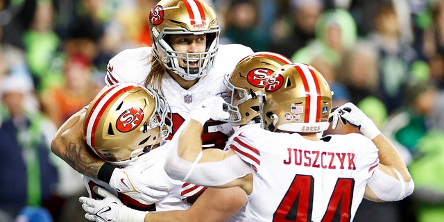 George Kittle #85 of the San Francisco 49ers celebrates with teammates after scoring a touchdown against the Seattle Seahawks during the third quarter of the game at Lumen Field on December 15, 2022 in Seattle, Washington. 