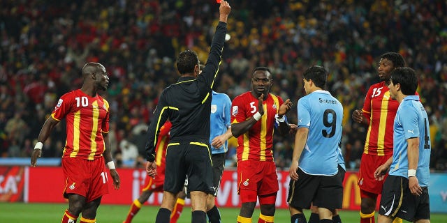 Luis Suarez of Uruguay is sent off by Referee Olegario Benquerenca after handling the ball on the goal line during the 2010 FIFA World Cup South Africa Quarter Final match between Uruguay and Ghana at the Soccer City stadium on July 2, 2010, in Johannesburg, South Africa.