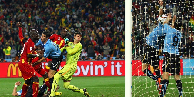 Luis Suarez of Uruguay handles the ball on the goal line, for which he is sent off, during the 2010 FIFA World Cup South Africa Quarter Final match between Uruguay and Ghana at the Soccer City stadium on July 2, 2010, in Johannesburg, South Africa.