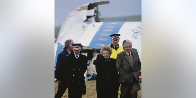 British Prime Minister Margaret Thatcher with police officers at the wreck of Pan Am Flight 103 after it crashed onto the town of Lockerbie in Scotland, December 22, 1988.