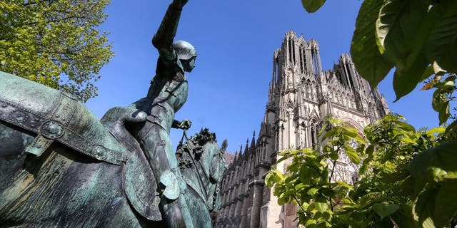 A statue of Jeanne D'Arc (Joan of Arc) is seen in the grounds of the medieval Roman Catholic Notre-Dame de Reims Cathedral, also known as Our Lady of Reims on April 17, 2019. The High Gothic style cathedral is where the kings of France were crowned, hosting 33 sovereign coronations in over 1,000 years.