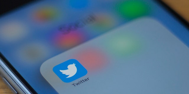 The Twitter logo is seen on a phone in this photo illustration in Washington, DC, on July 10, 2019.