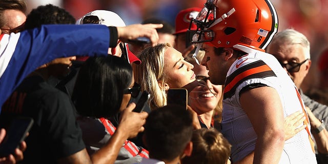 Quarterback Baker Mayfield #6 of the Cleveland Browns kisses Emily Wilkinson before the game against the Francisco 49ers at Levi's Stadium on October 07, 2019 in Santa Clara, California.