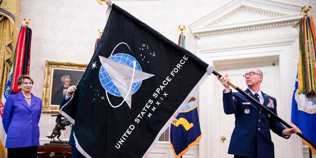 The official flag of the United States Space Force in the Oval Office of the White House in Washington, DC.