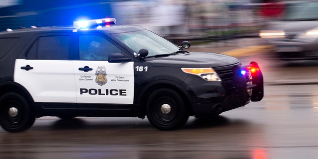 A police car drives swiftly outside the 3rd Precinct Police Precinct on May 26, 2020 in Minneapolis, Minnesota. 