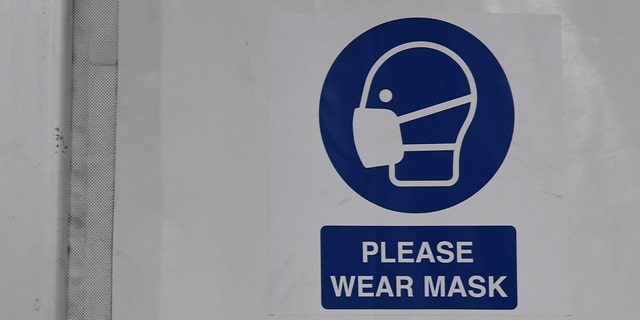A sign inside a tent reminds people to wear masks at the joint Clark County-City of Las Vegas ISO-Q (Isolation and Quarantine) Complex for the homeless that was constructed in the parking lot at Cashman Center in response to the coronavirus pandemic on April 13, 2020, in Las Vegas.
