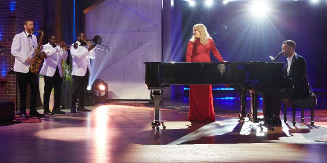 Kelly Clarkson (middle) and John Legend (far right) sing 'Baby, It's Cold Outside' with rewritten lyrics during a stage performance they recorded for ‘The Kelly Clarkson Show’ (Episode 3072) on Nov. 18, 2019.