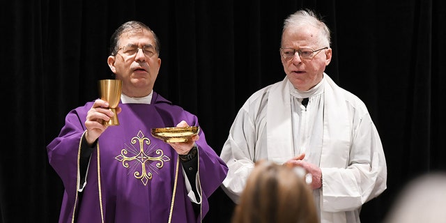Frank Pavone (at left), the national director of Priests for Life, celebrates Catholic Mass for attendees at the 2021 Conservative Political Action Conference at the Hyatt Regency in Orlando, Florida. Pavone has been "laicized," or defrocked, by the Catholic Church.