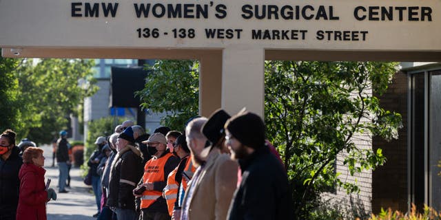 Pro-life demonstrators and clinic escorts stand in front of the EMW Womens Surgical Center, an abortion clinic, on May 8, 2021, in Louisville, Kentucky. (Photo by Jon Cherry/Getty Images)