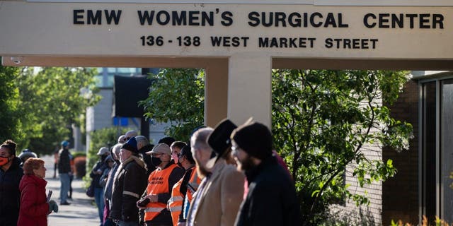 Pro-life demonstrators and clinic escorts stand in front of the EMW Women's Surgical Center on May 8, 2021, in Louisville.